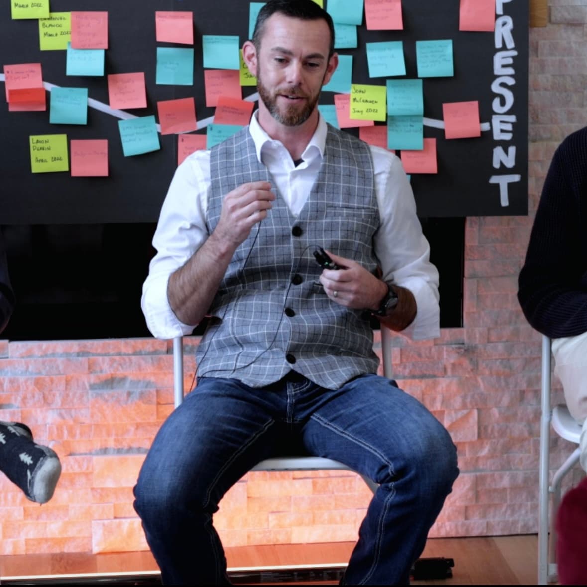 David Forster presenting at an event with post-it notes on the wall